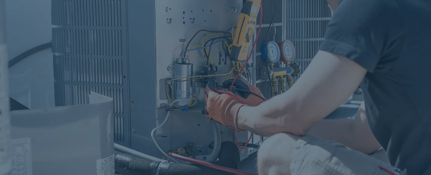 hvac technician working on gray hvac unit tucson az