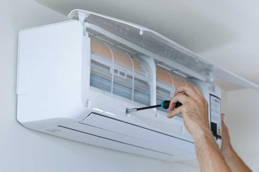 technician with a screwdriver doing a mini split repair oro valley az